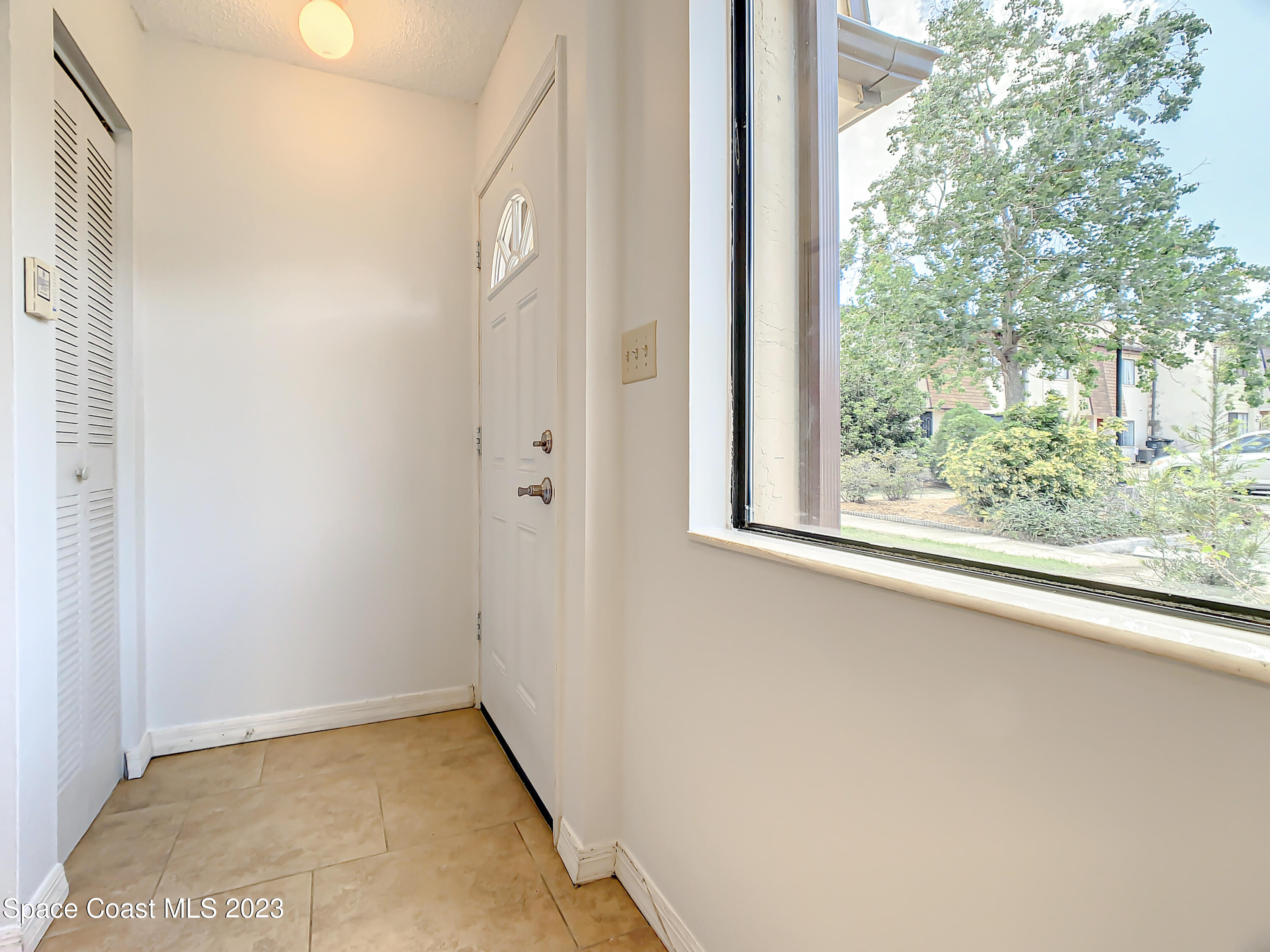 4859 Sisson Road Titusville, FL 32780 - Photo 5 of 30 a view of a small space with wooden floor and a window