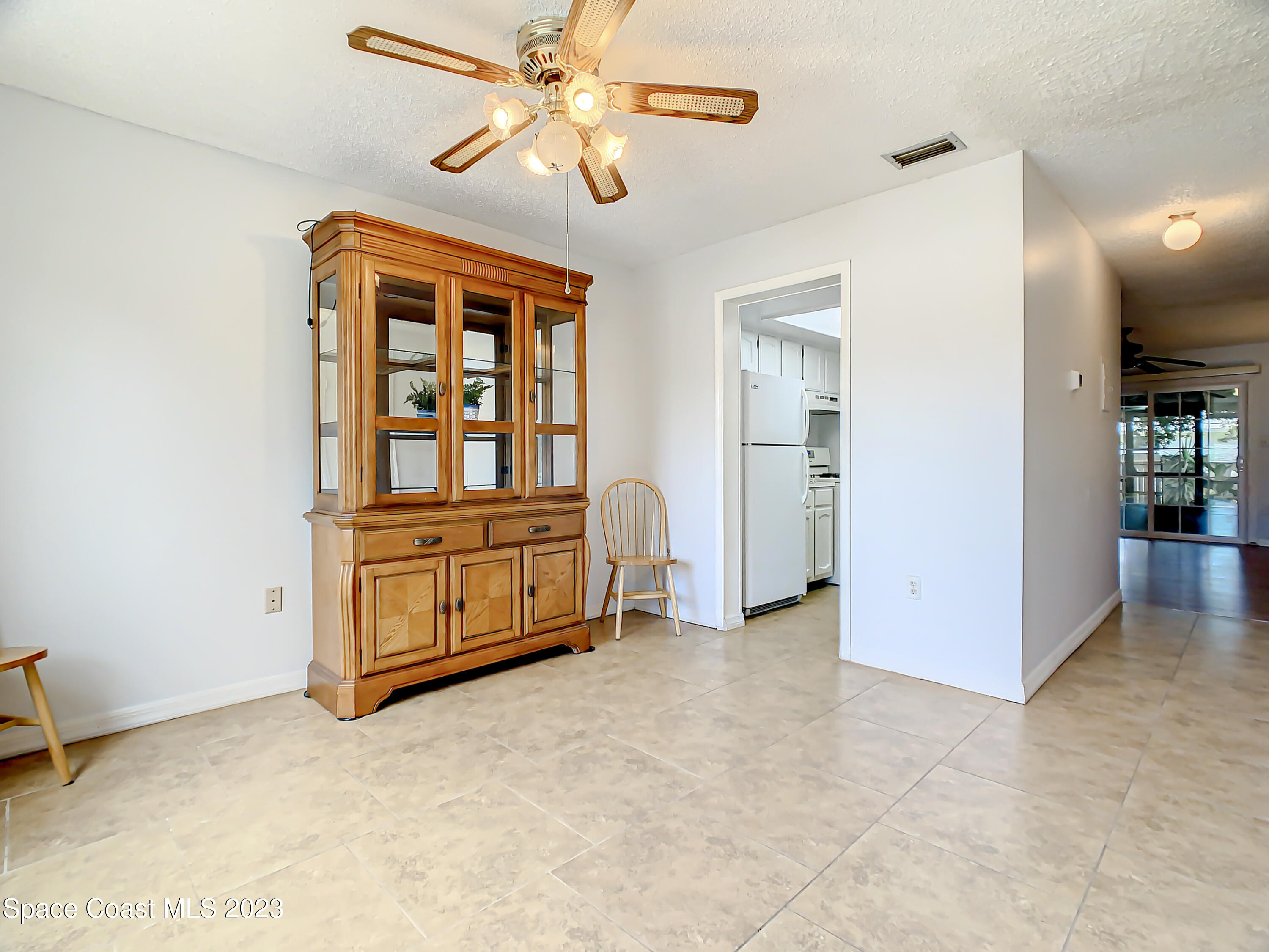 4859 Sisson Road Titusville, FL 32780 - Photo 6 of 30 an empty room with chandelier fan and windows