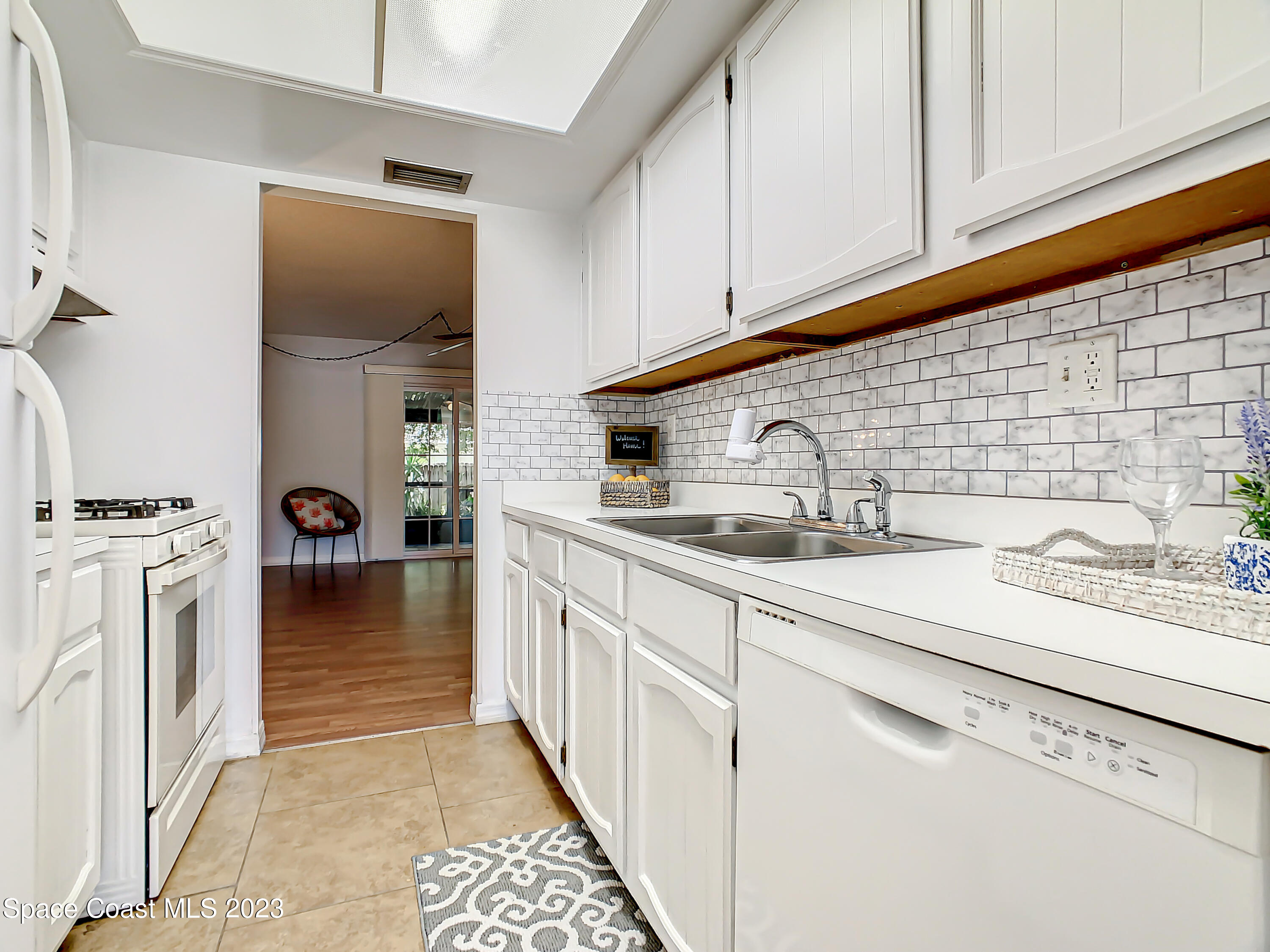 4859 Sisson Road Titusville, FL 32780 - Photo 7 of 30 a kitchen with stainless steel appliances granite countertop a sink and cabinets
