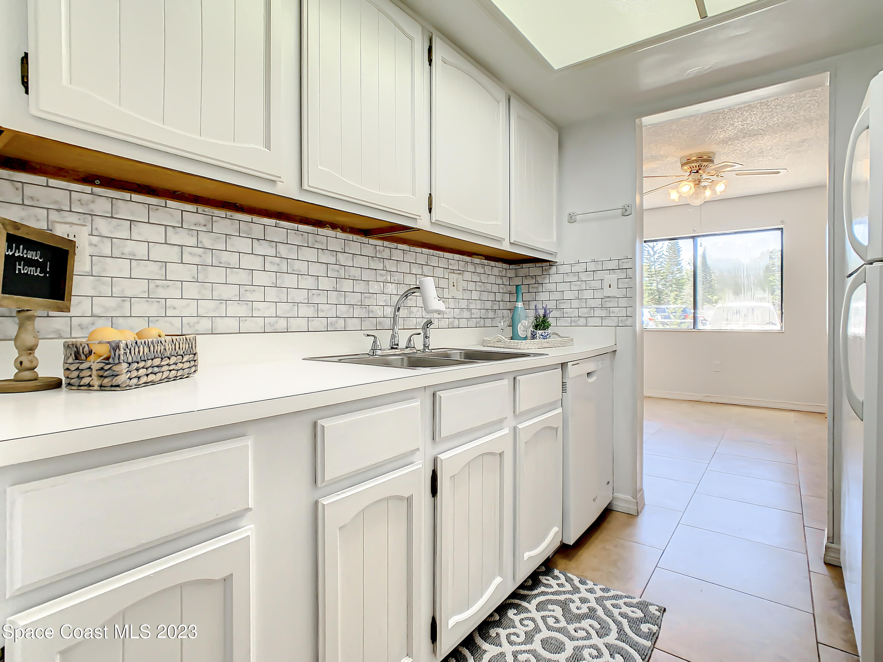4859 Sisson Road Titusville, FL 32780 - Photo 8 of 30 a kitchen with stainless steel appliances granite countertop a sink and a white cabinets