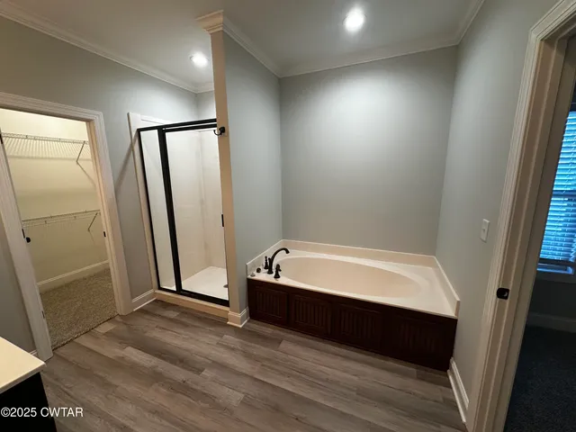 a spacious bathroom with a bathtub and a shower
