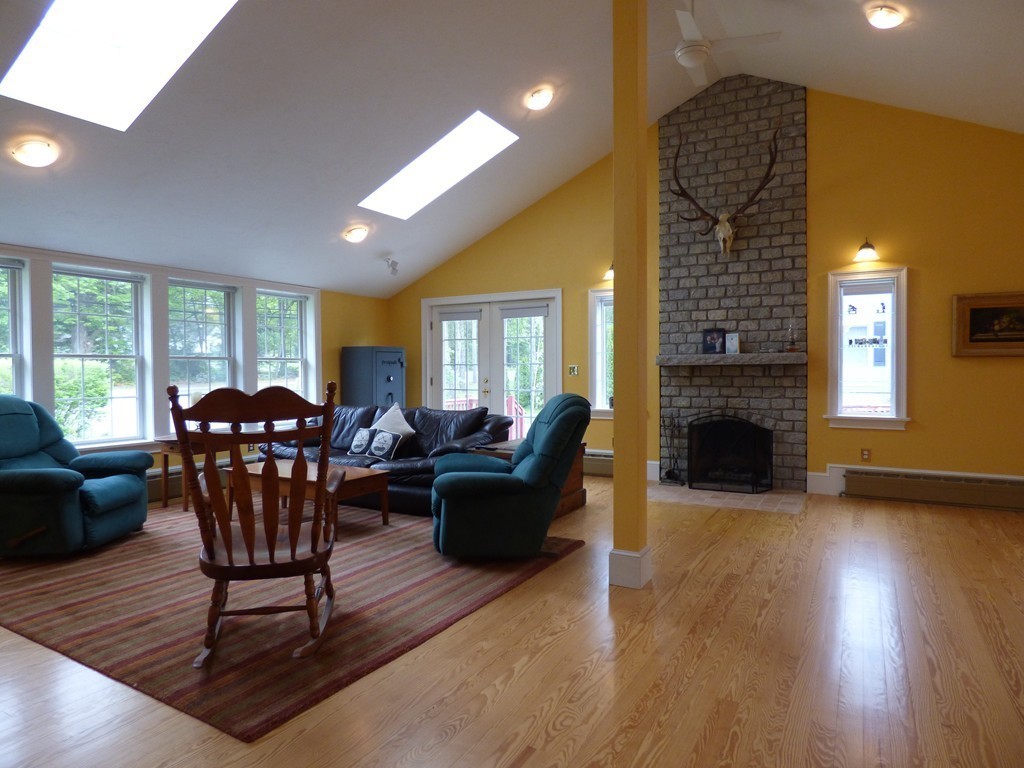 345 Ayer Road Harvard, MA 01451 - Photo 7 of 30 a living room with furniture a dining table and a fireplace