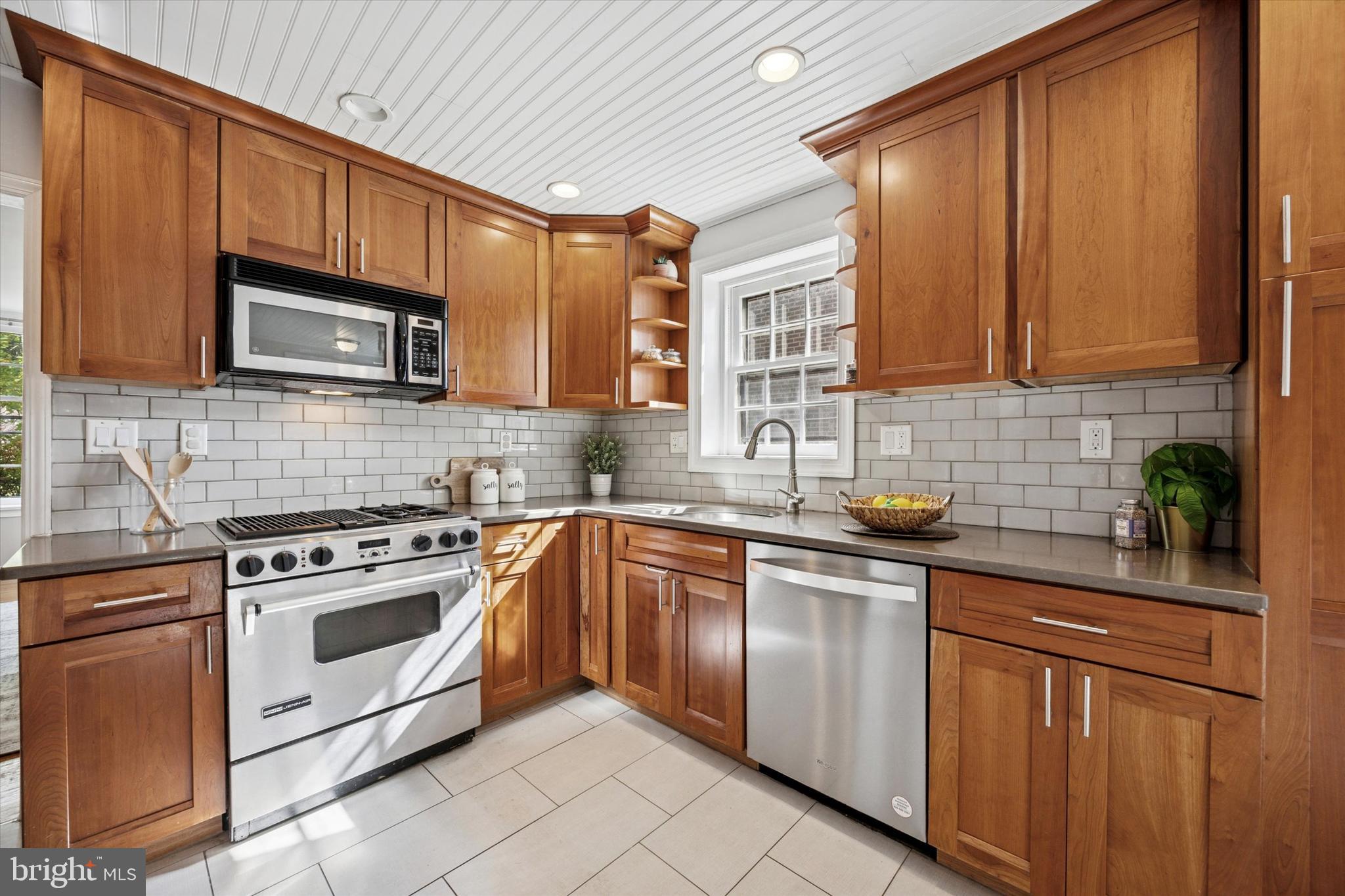 1612 Earlington Road Havertown, PA 19083 - Photo 11 of 35 a kitchen with stainless steel appliances granite countertop wooden cabinets a stove top oven a sink and dishwasher