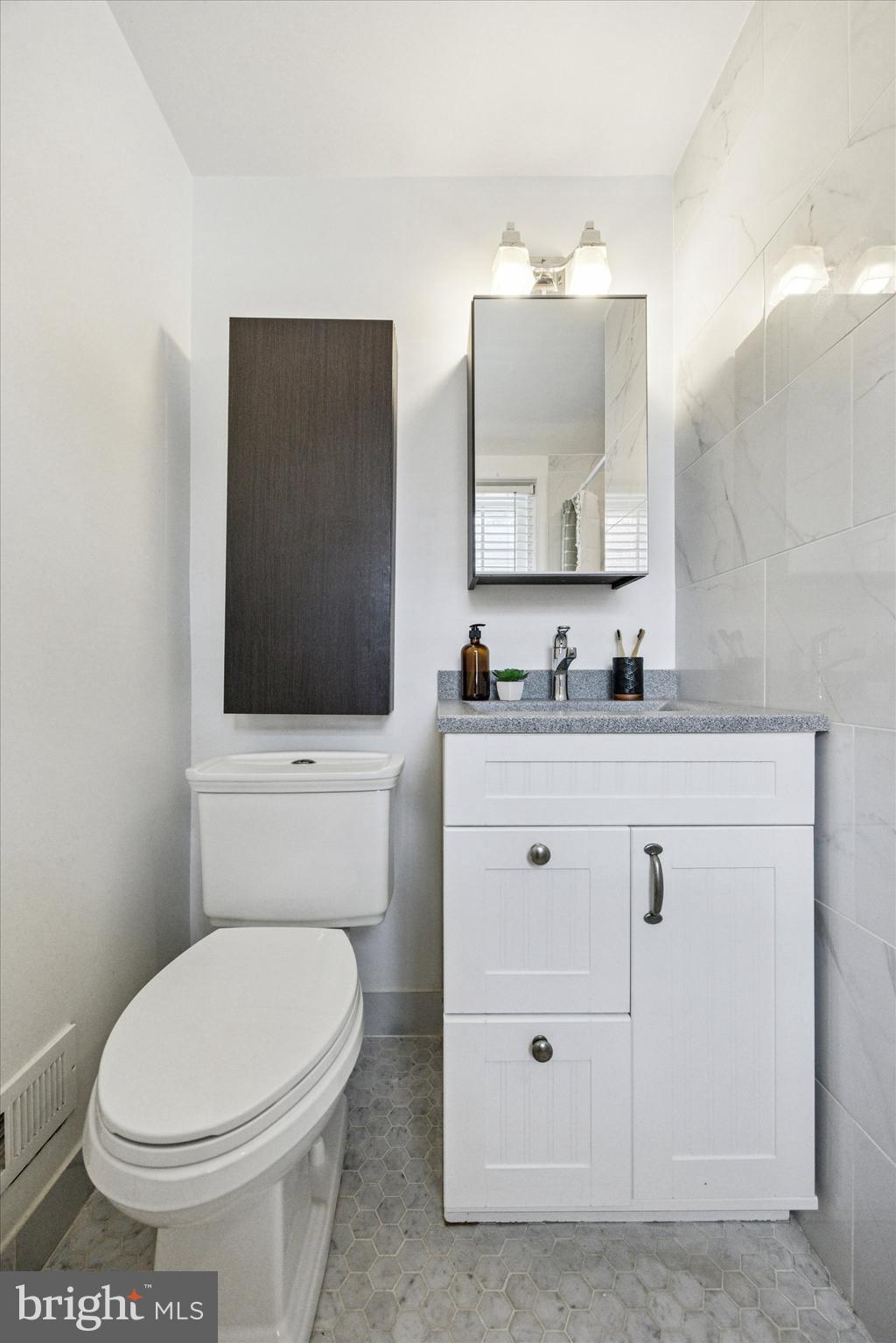 1612 Earlington Road Havertown, PA 19083 - Photo 19 of 35 a bathroom with a toilet sink and mirror