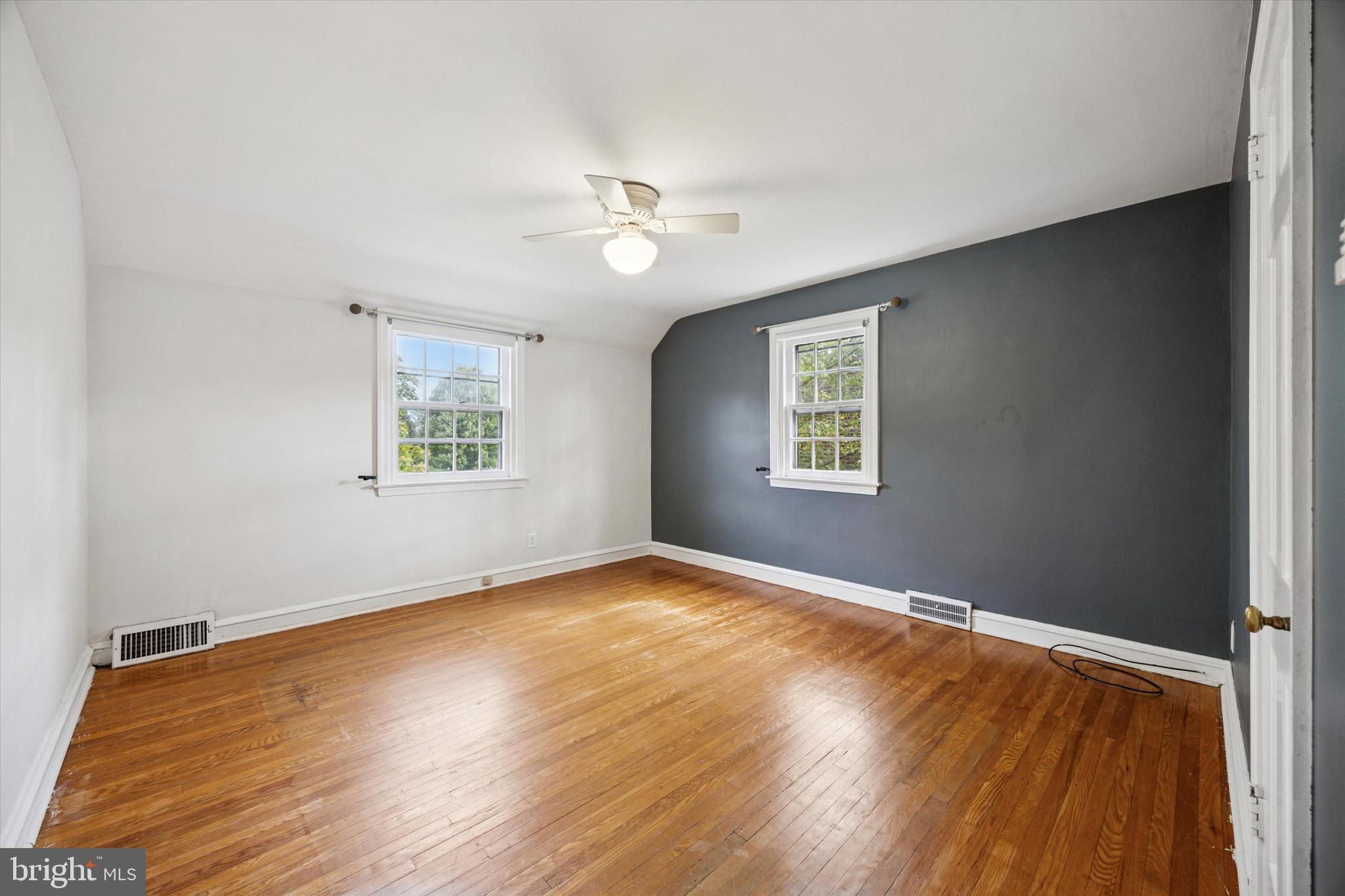 1612 Earlington Road Havertown, PA 19083 - Photo 21 of 35 a view of an empty room with a window and wooden floor