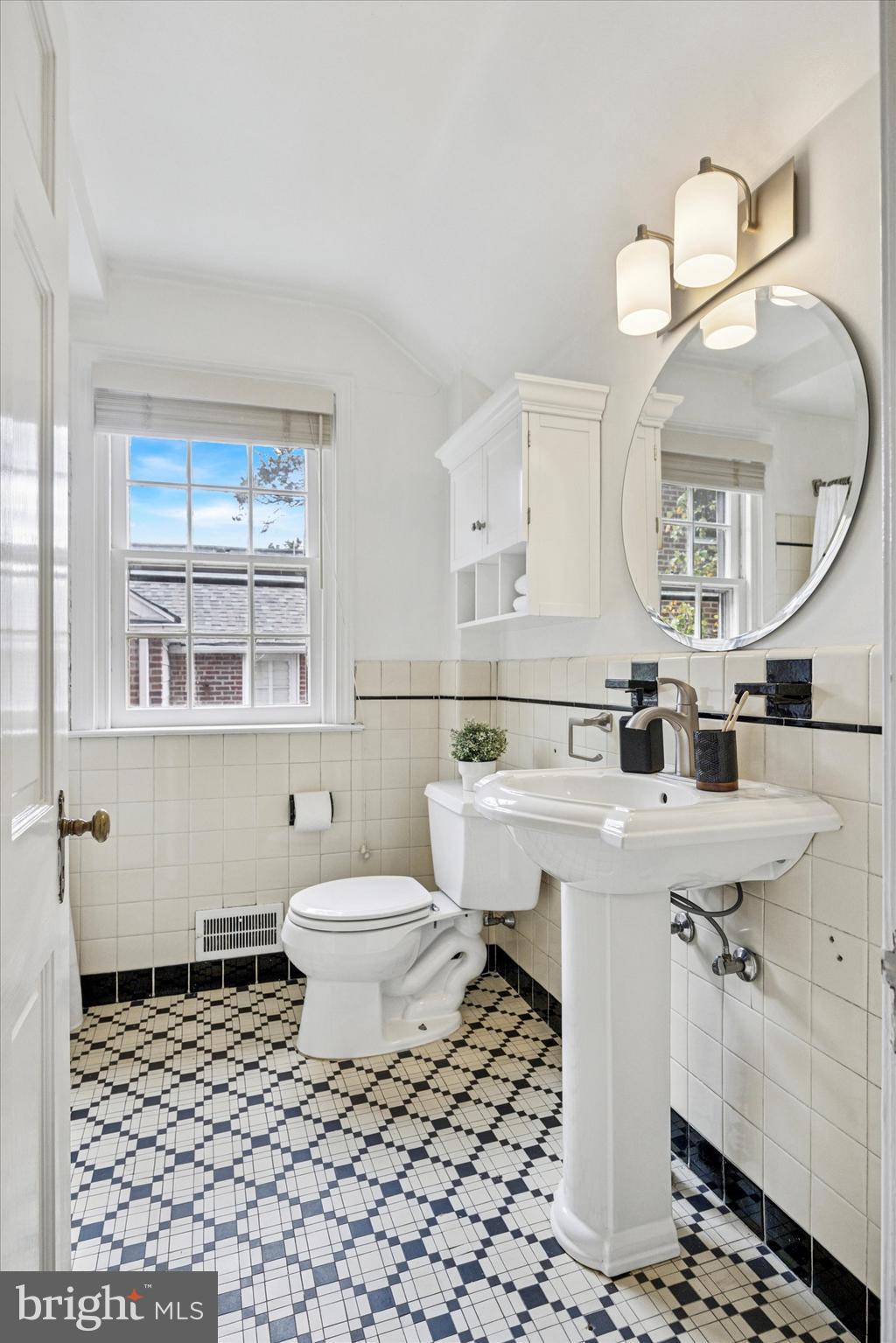 1612 Earlington Road Havertown, PA 19083 - Photo 24 of 35 a bathroom with a sink toilet a mirror and vanity