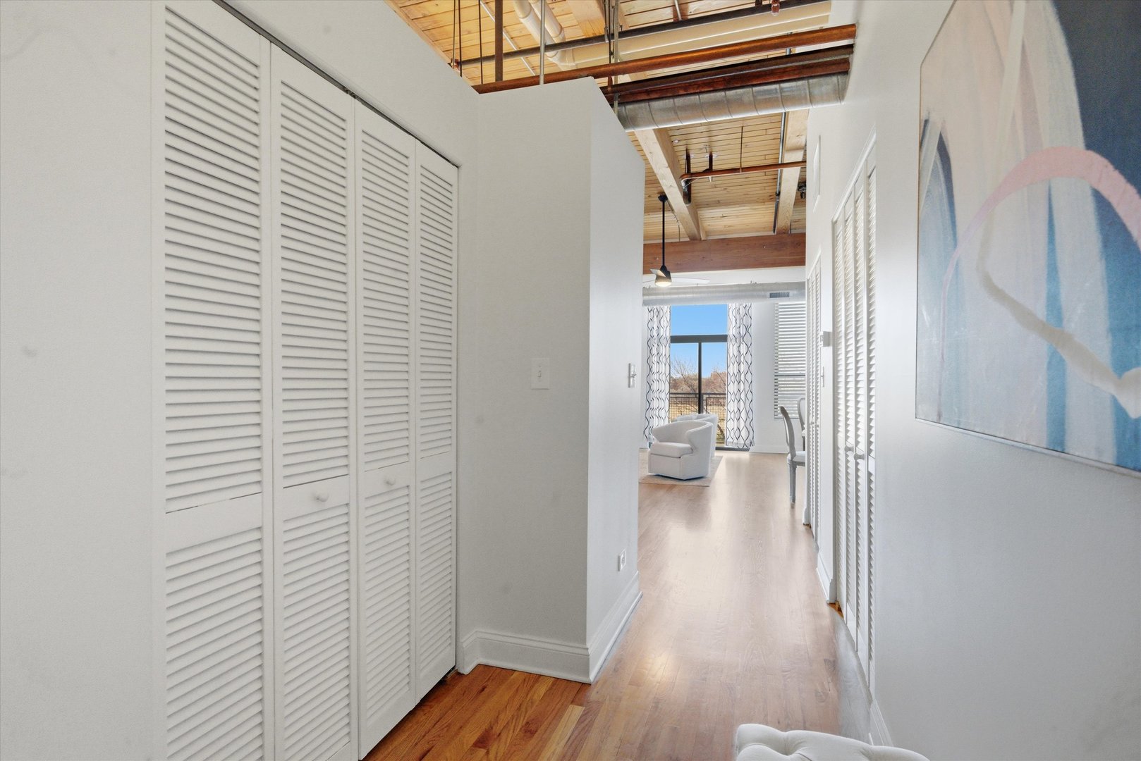 1610 South Halsted Street, Unit 401 Chicago, IL 60608 - Photo 16 of 31 a view of a hallway with wooden floor and a bathroom