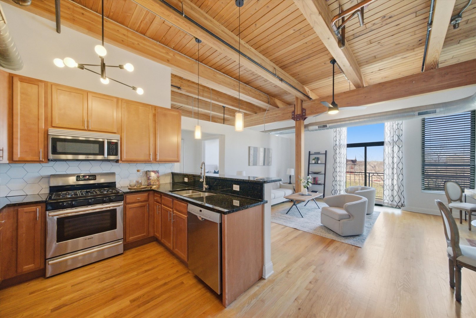 1610 South Halsted Street, Unit 401 Chicago, IL 60608 - Photo 2 of 31 a kitchen with stainless steel appliances granite countertop wooden cabinets a sink stove and granite counter top