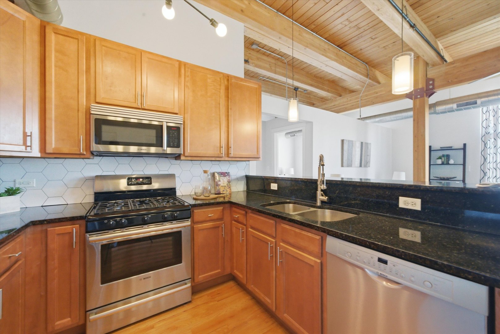 1610 South Halsted Street, Unit 401 Chicago, IL 60608 - Photo 7 of 31 a kitchen with granite countertop a sink a stove and cabinets