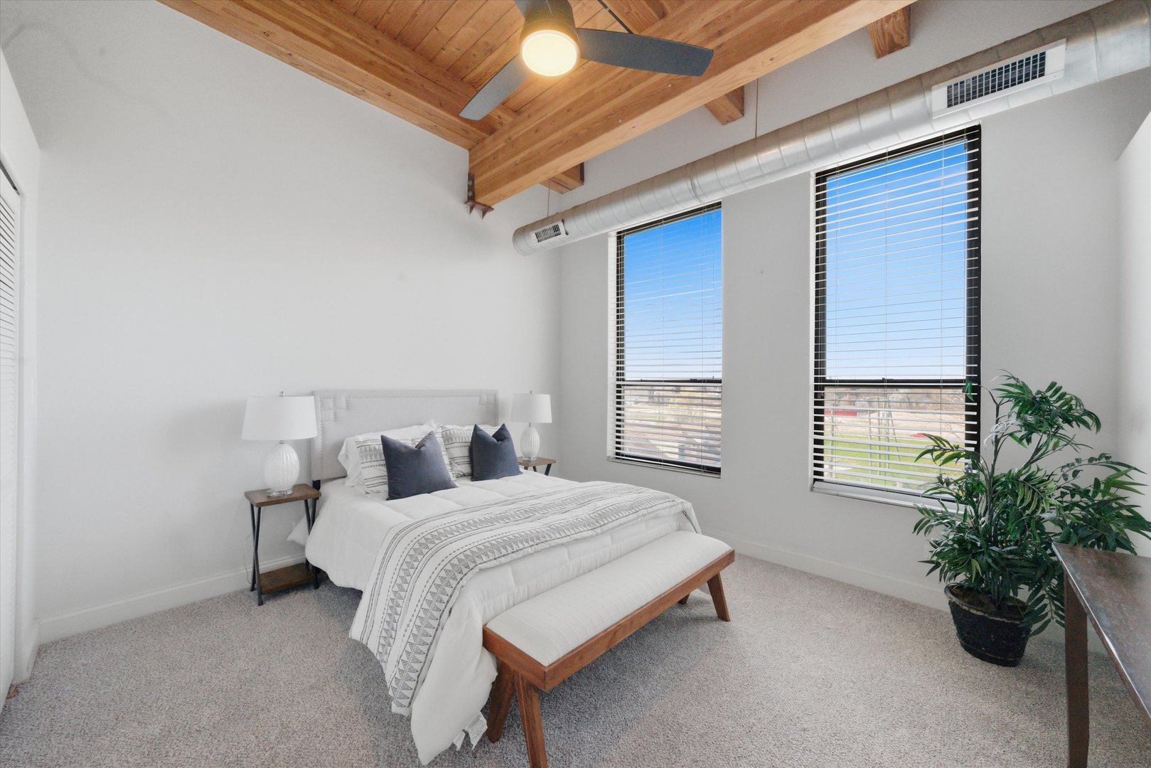 1610 South Halsted Street, Unit 401 Chicago, IL 60608 - Photo 10 of 31 a bedroom with a bed and a potted plant