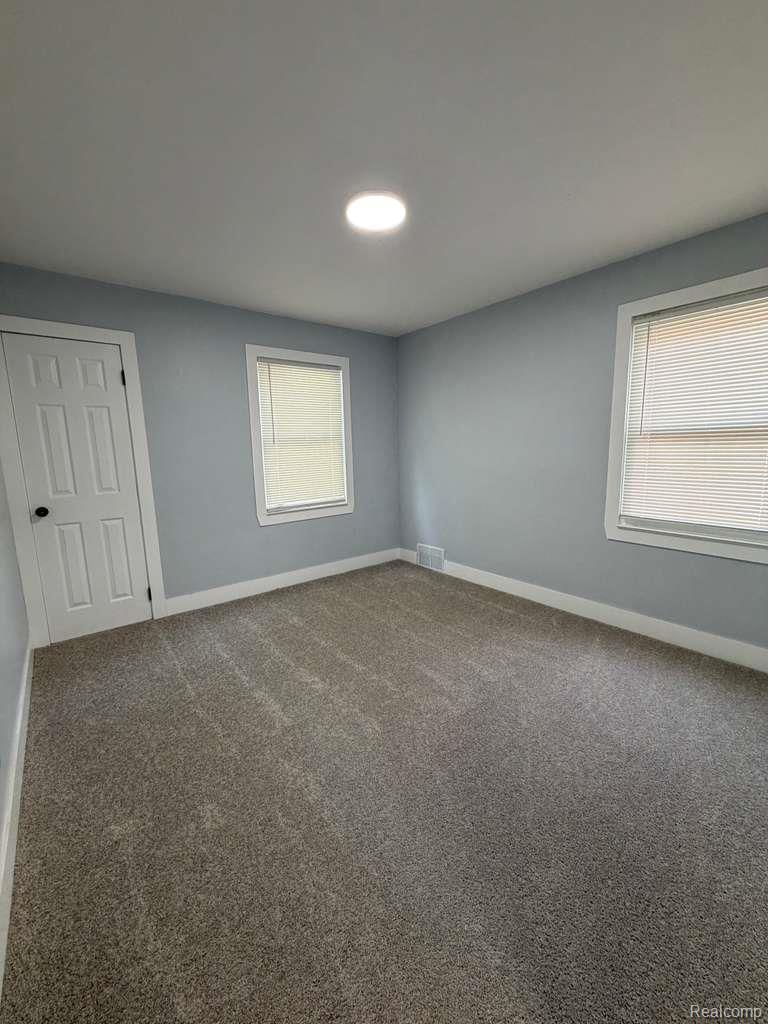 7416 Heyden Detroit, MI 48228 - Photo 6 of 16 Spare room featuring carpet and baseboards
