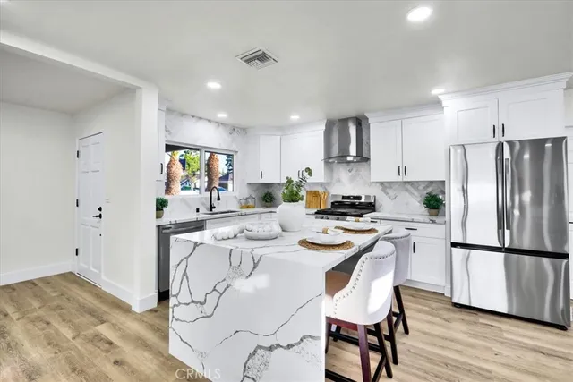 a kitchen with cabinets appliances and a window