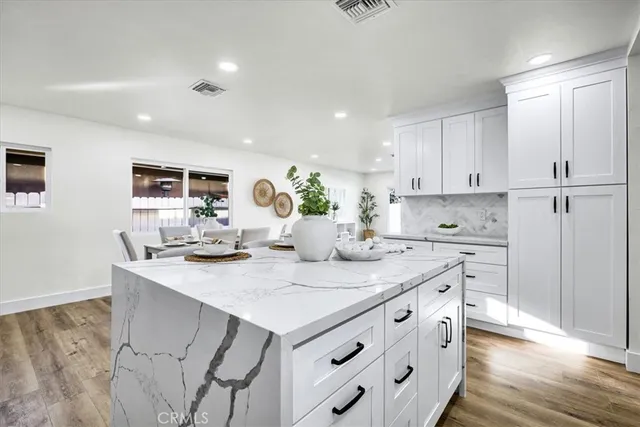 a bathroom with a granite countertop sink mirror vanity and toilet