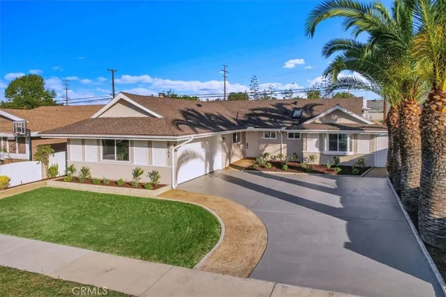 a front view of a house with a yard table and chairs