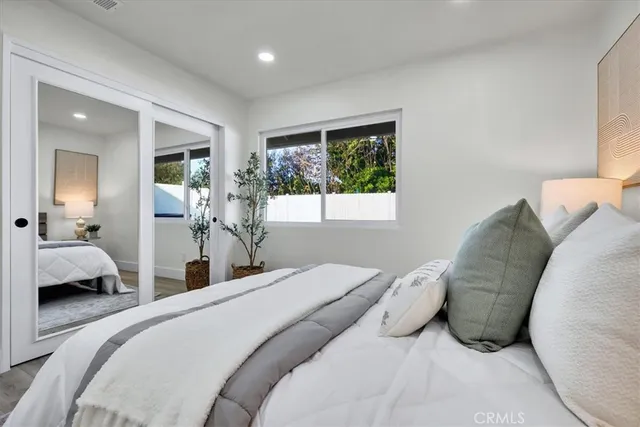 a bedroom with a large bed and a large window
