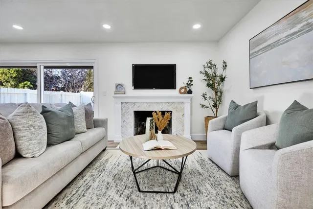 a living room with furniture fireplace and window