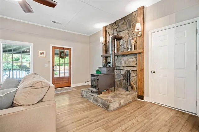 a living room with furniture a flat screen tv and a large window
