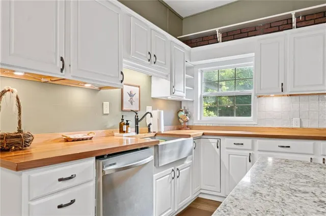 a kitchen with a sink cabinets and window