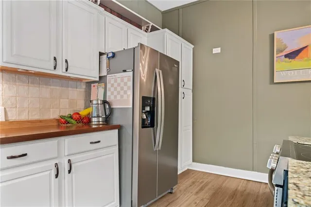 a kitchen with stainless steel appliances a refrigerator and cabinets