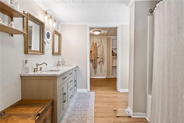 a bathroom with a sink a mirror and a shower