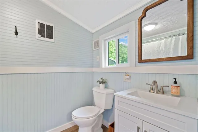 a bathroom with a sink a toilet and a window