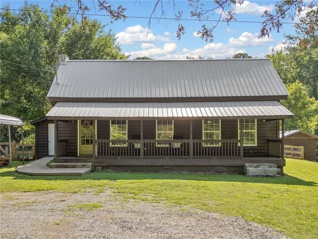 a front view of house with a garden