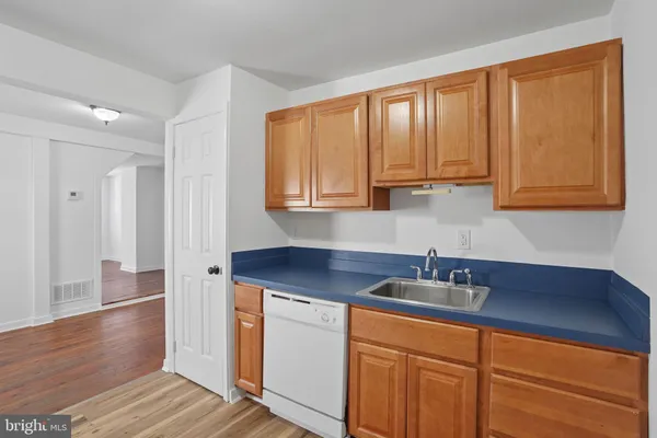 a kitchen with stainless steel appliances granite countertop wooden cabinets a sink and dishwasher