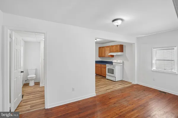 a view of a kitchen with a sink and dishwasher wooden floor