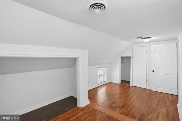 a view of room with wooden floor