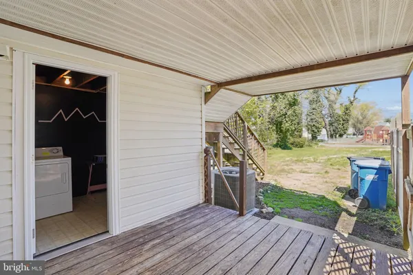 a view of a porch with wooden floor and outdoor space