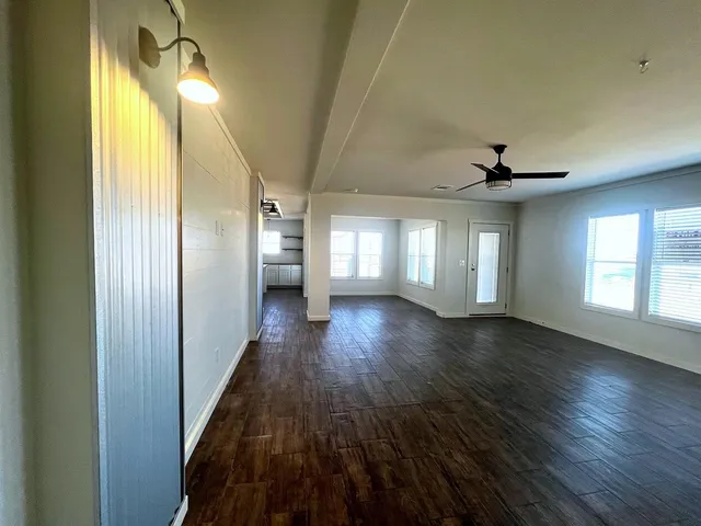 a view of hallway with wooden floor