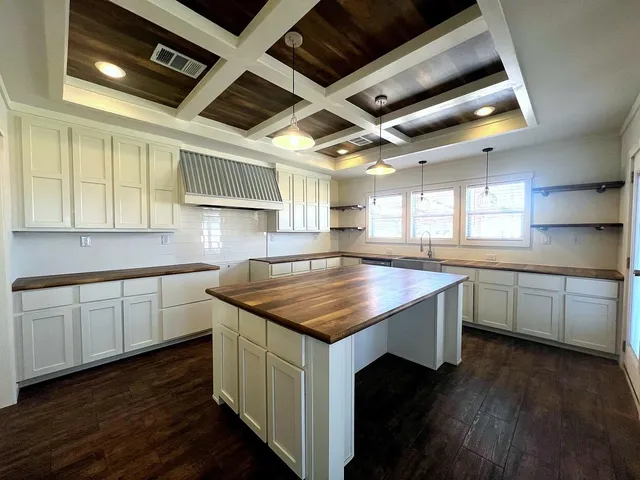 a kitchen with sink cabinets and wooden floor