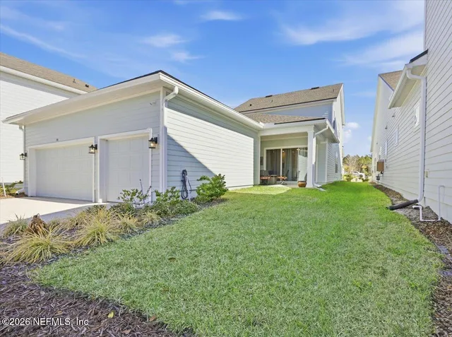 a view of a house with backyard and garden