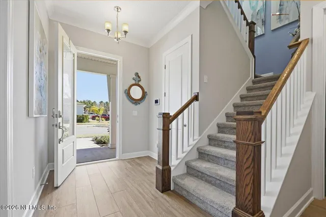 a view of entryway and hall with wooden floor