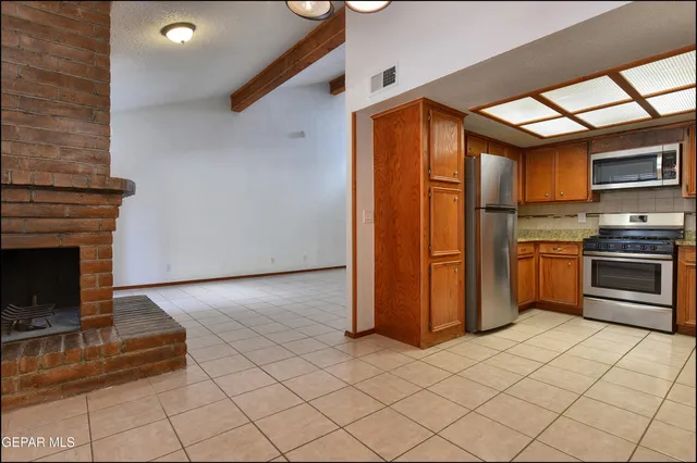 a bathroom with a granite countertop sink a toilet a mirror and bathtub