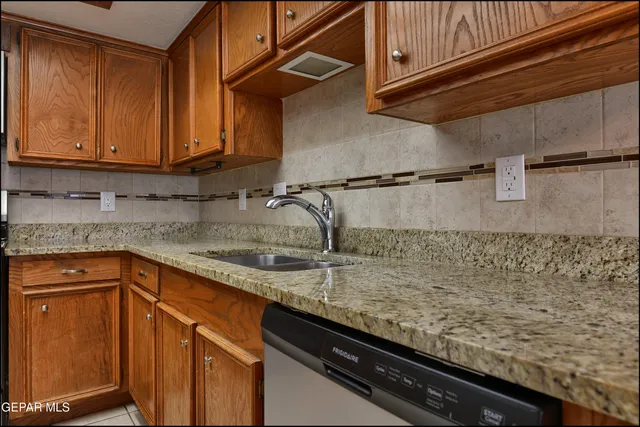 an empty room with a chandelier fan and windows