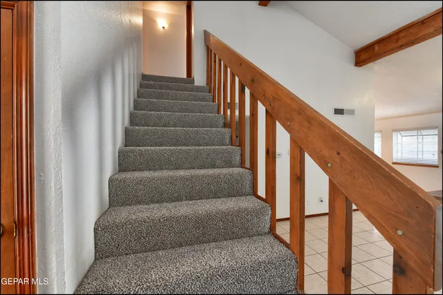 a bathroom with a granite countertop sink and a toilet