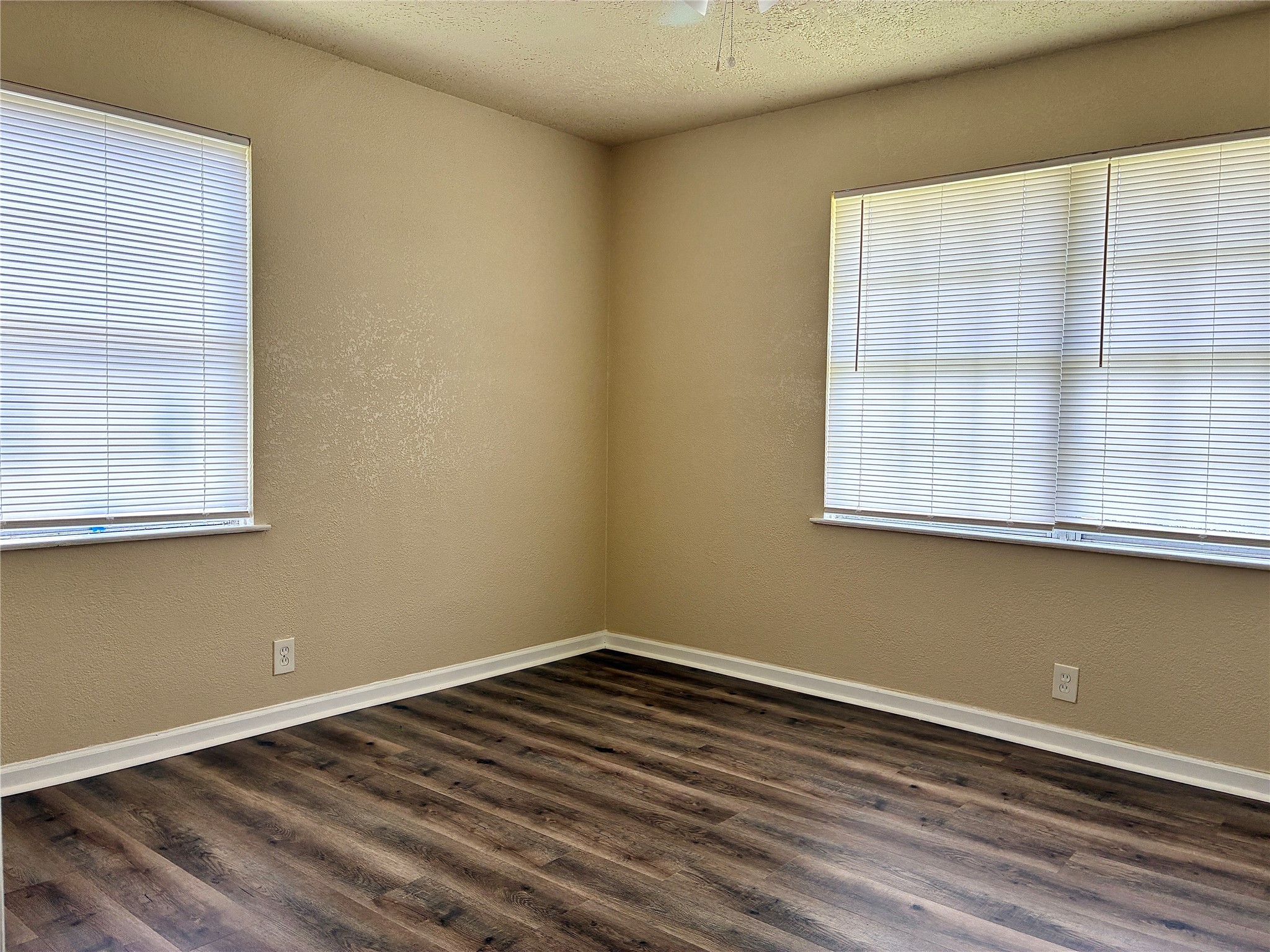 631 Roper Street Houston, TX 77034 - Photo 7 of 15 The first front bedroom features fresh paint, new vinyl plank flooring, and a new ceiling fan.