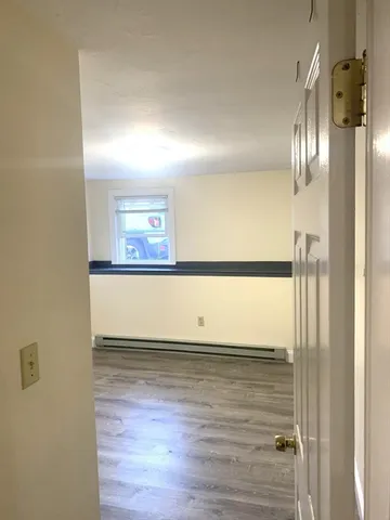 a view of a room with wooden floor