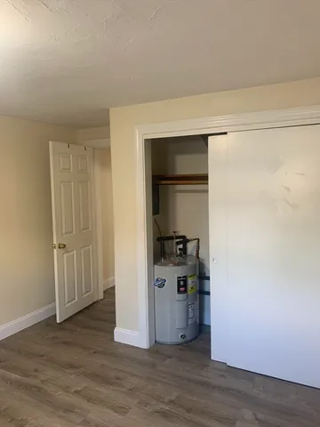 a view of a kitchen with wooden floor and cabinets