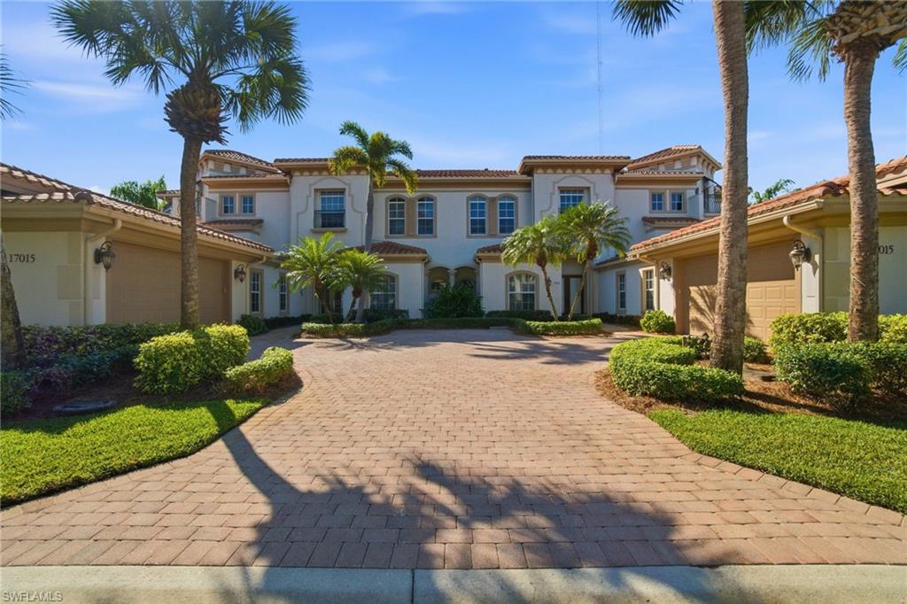 17015 Porta Vecchio Way, Unit 101 Naples, FL 34110 - Photo 26 of 39 a front view of a residential houses with yard