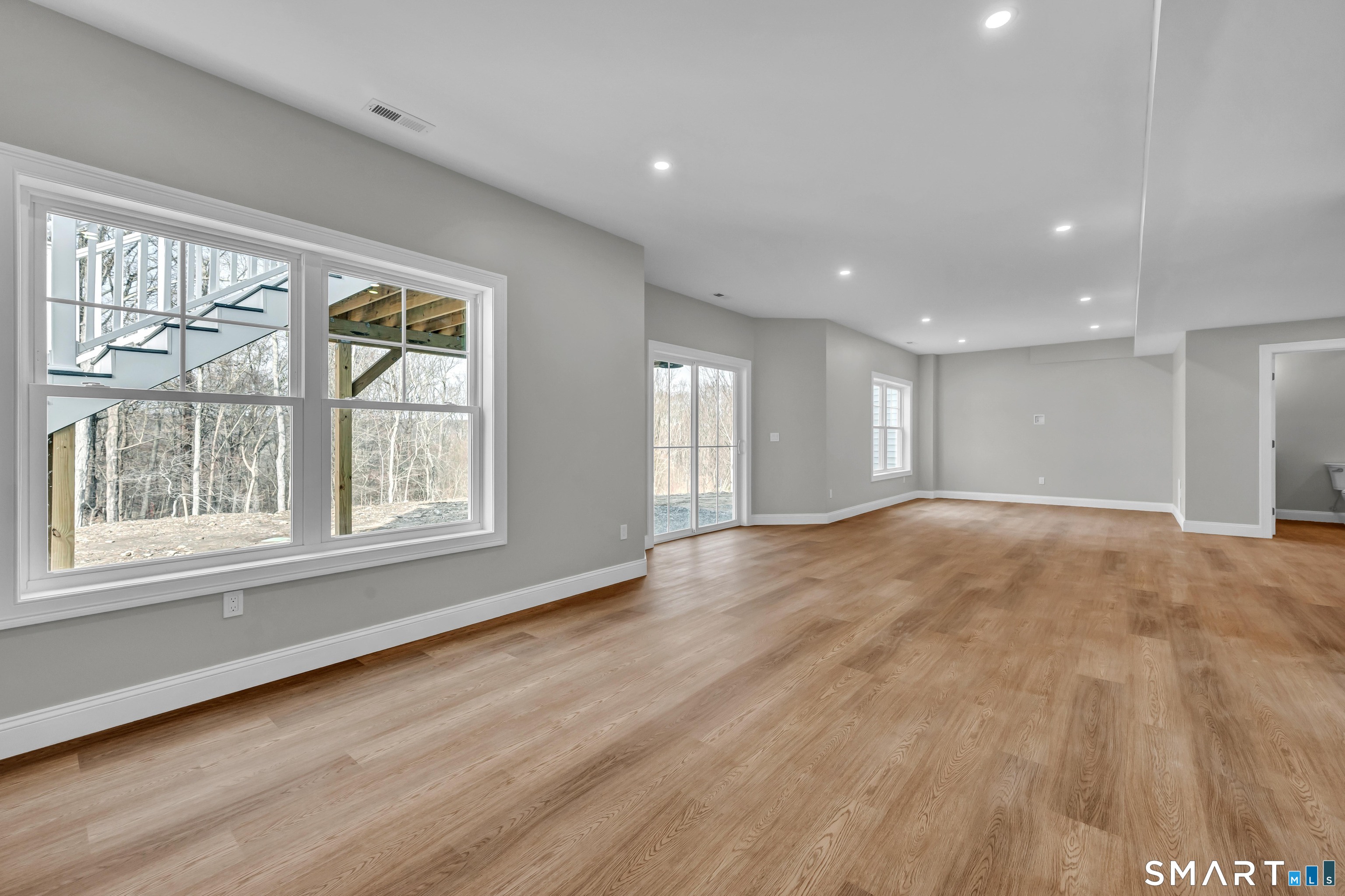 1427 Monroe Turnpike Monroe, CT 06468 - Photo 32 of 41 an empty room with wooden floor and windows