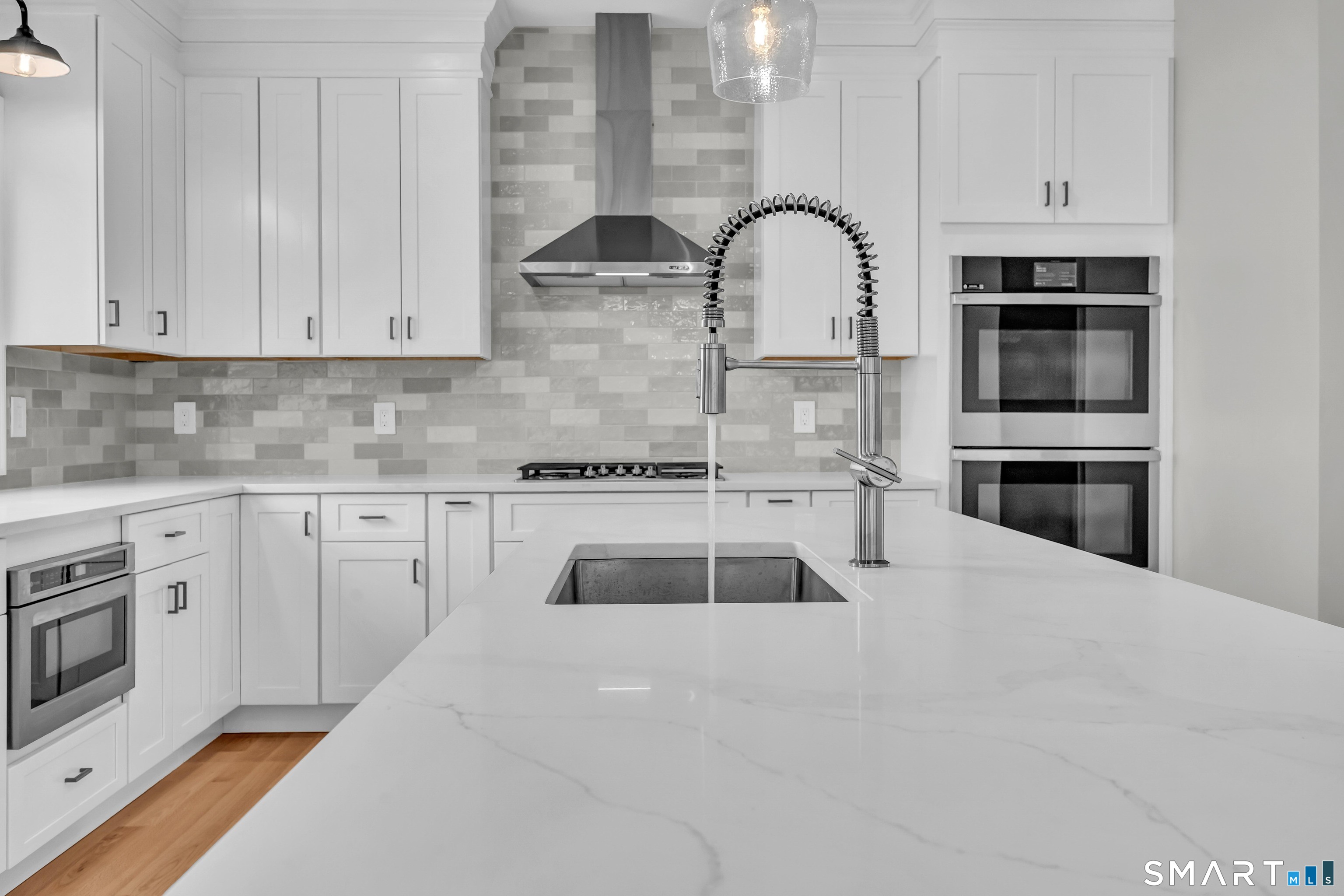 1427 Monroe Turnpike Monroe, CT 06468 - Photo 5 of 41 a kitchen with granite countertop a stove a microwave and cabinets