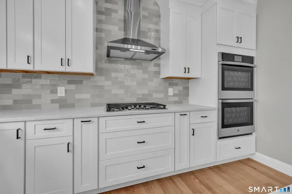 a kitchen with stainless steel appliances a stove sink and refrigerator