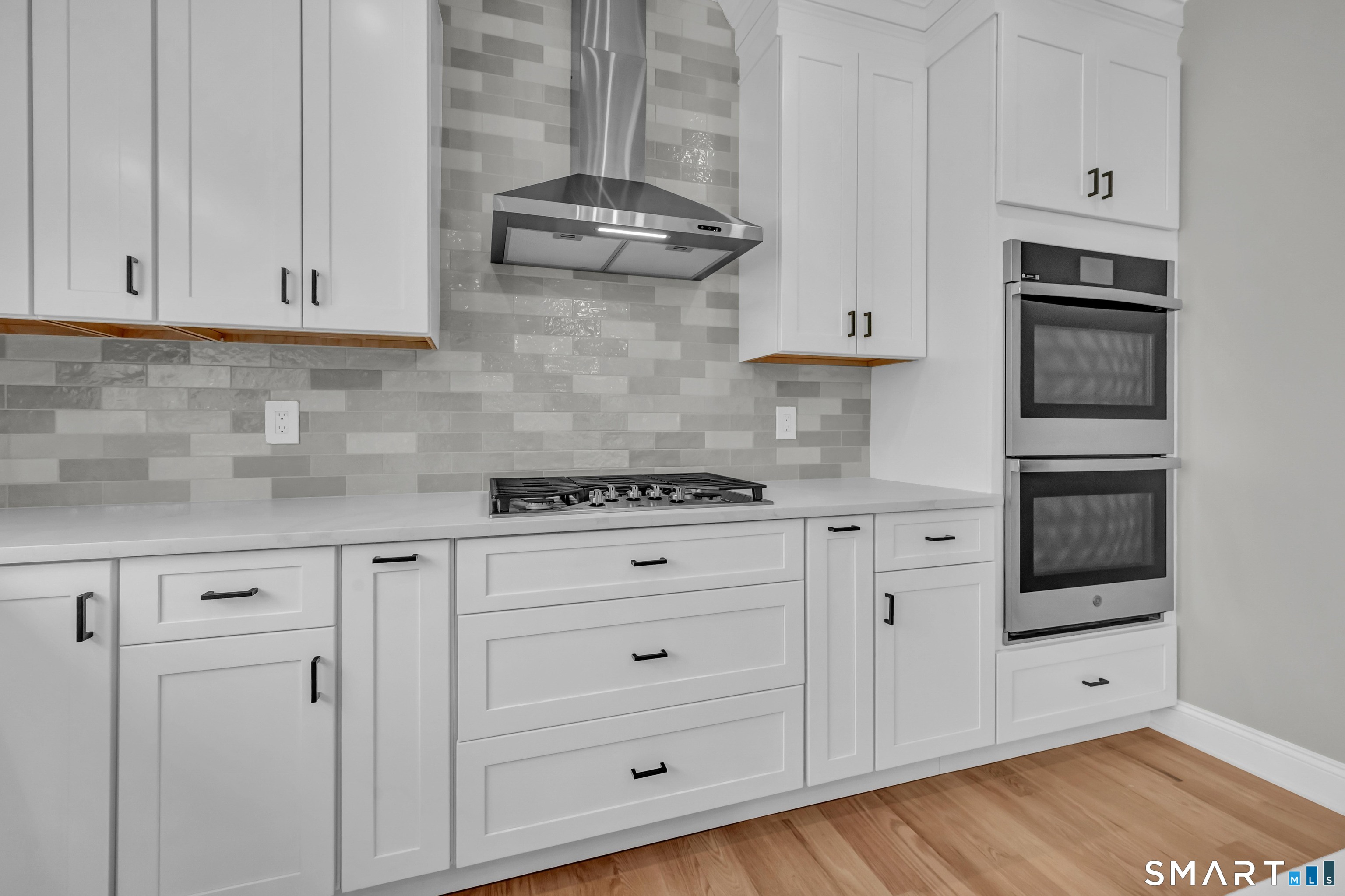 1427 Monroe Turnpike Monroe, CT 06468 - Photo 6 of 41 a kitchen with stainless steel appliances granite countertop a stove a sink and white cabinets