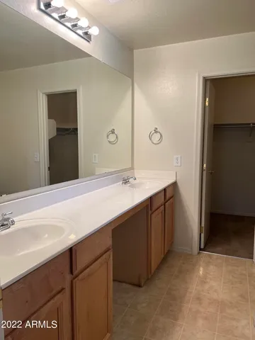 a bathroom with a sink a vanity and a mirror