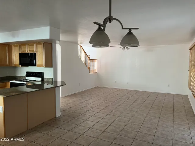 a kitchen with stainless steel appliances granite countertop a sink and a stove