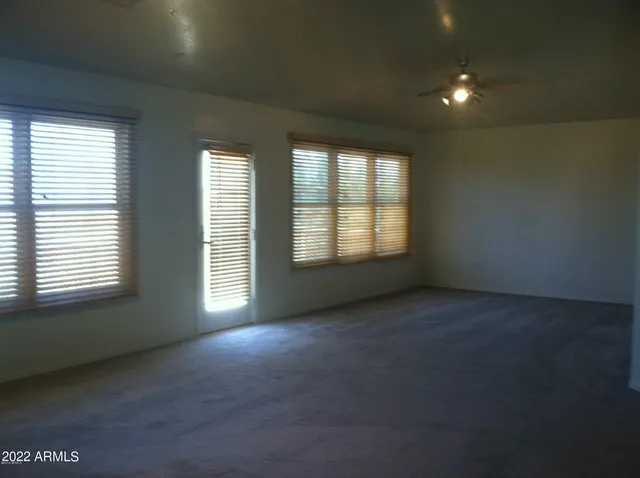 an empty room with a empty space and windows