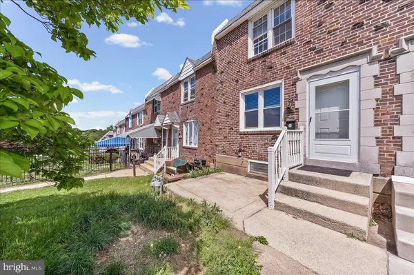 a view of a house with backyard porch and sitting area