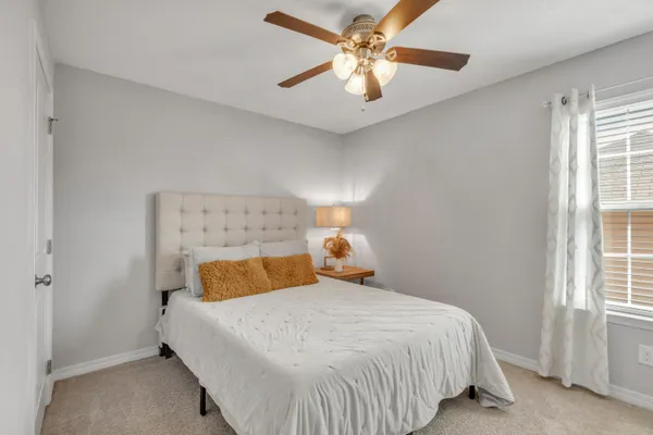 a bedroom with a bed and window